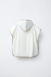 TEXTURED TOWEL PONCHO WITH FLORAL TRIM