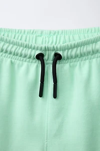 ATHLETIC SHORTS WITH RAISED TEXT