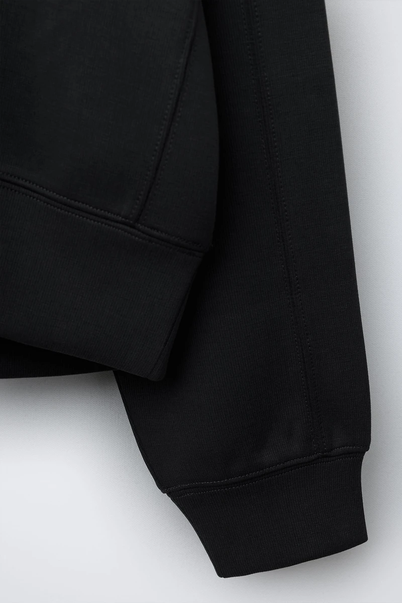 RAISED TEXT SWEATSHIRT