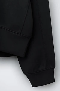 RAISED TEXT SWEATSHIRT