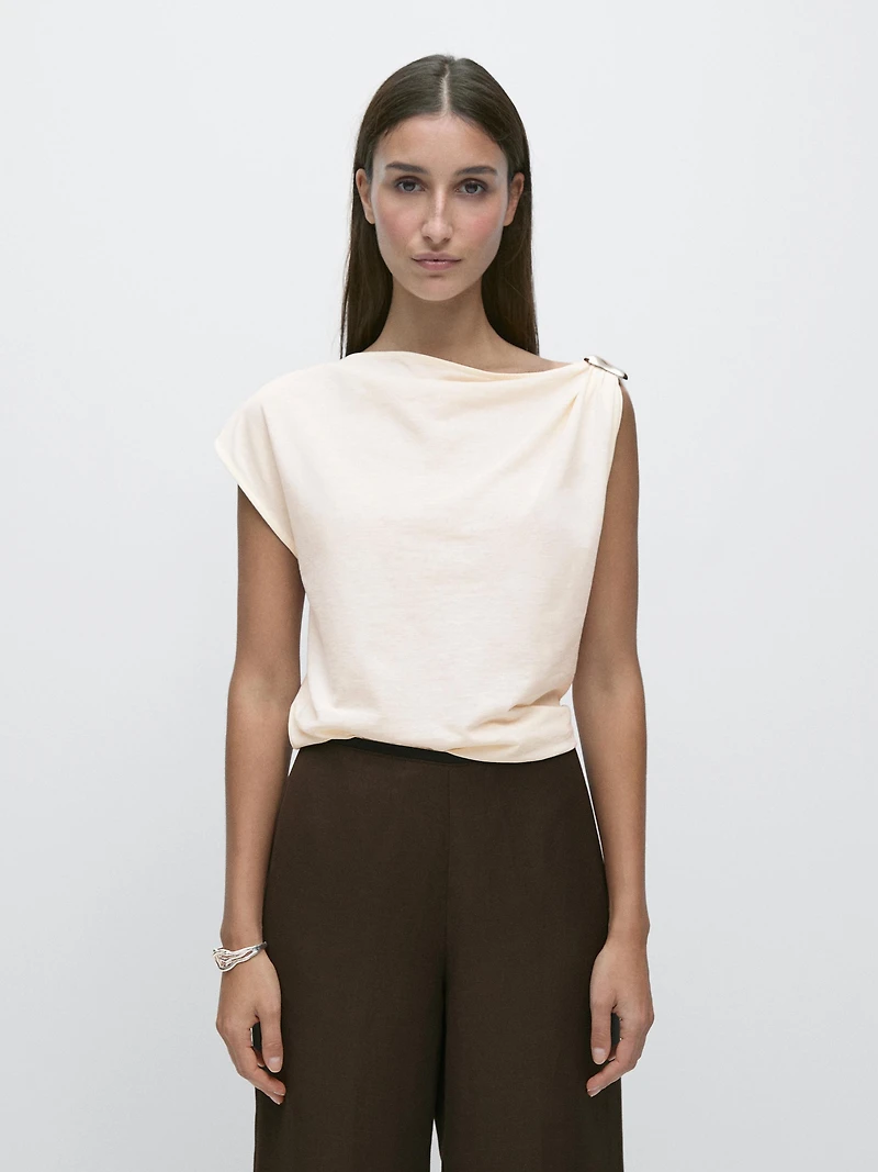 Asymmetric top with shoulder appliqué