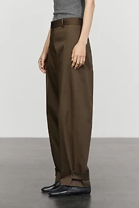 Pants with button-tab hem detail
