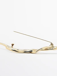 Abstract metal brooch