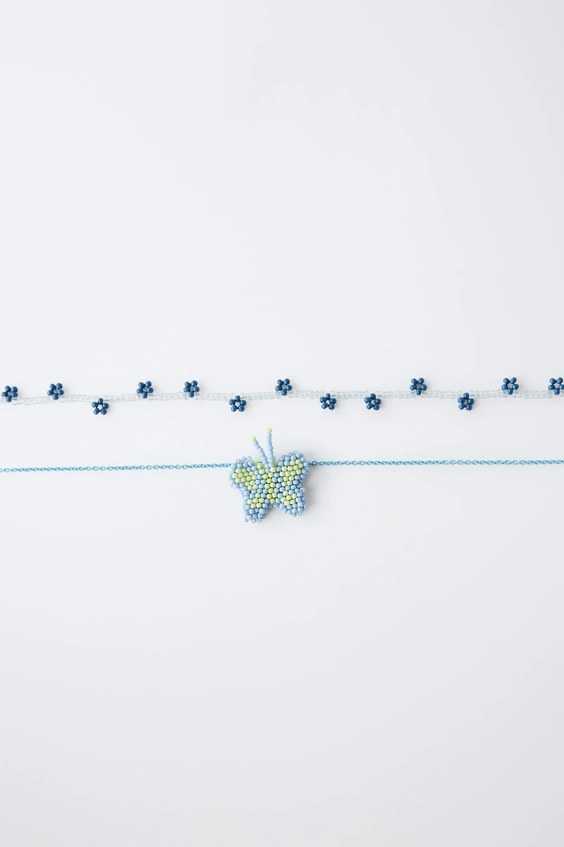 PACK OF TWO BUTTERFLY AND FLOWER BEADED NECKLACES