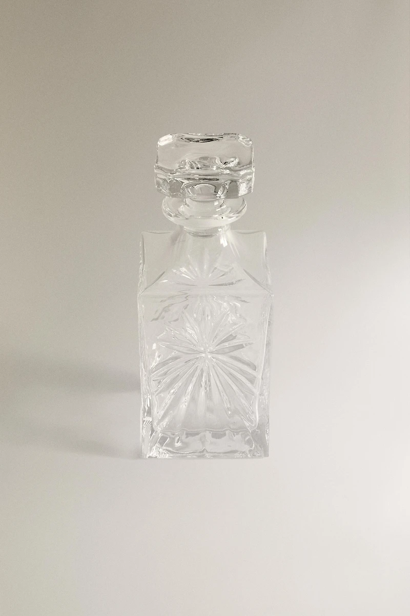 CRYSTALLINE BOTTLE WITH RAISED DESIGN