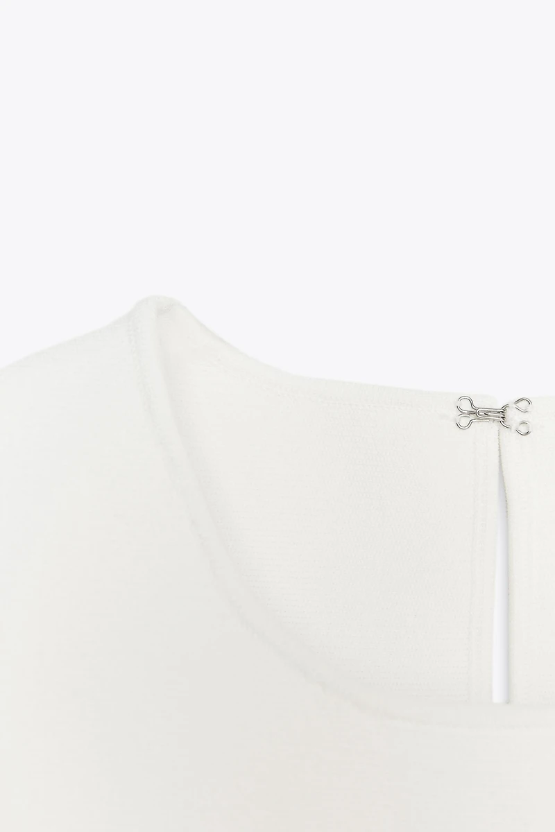 TOP EN MAILLE PÉPLUM AVEC LACETS