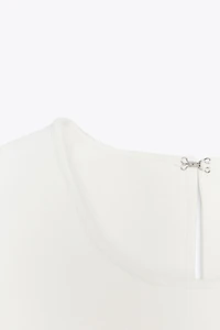 TOP EN MAILLE PÉPLUM AVEC LACETS
