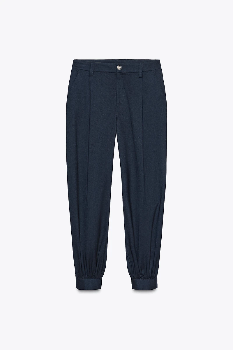PLEATED PANTS WITH BUTTONED HEM