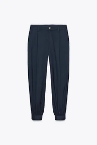PLEATED PANTS WITH BUTTONED HEM