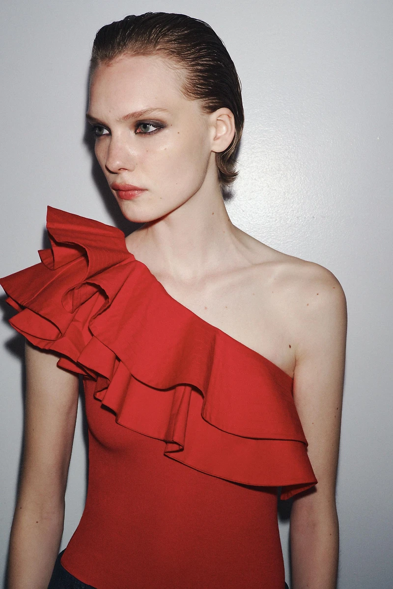 ASYMMETRIC BODYSUIT WITH CONTRASTING RUFFLE