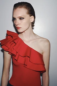 ASYMMETRIC BODYSUIT WITH CONTRASTING RUFFLE