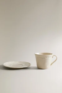 STONEWARE RAISED DESIGN COFFEE CUP AND SAUCER