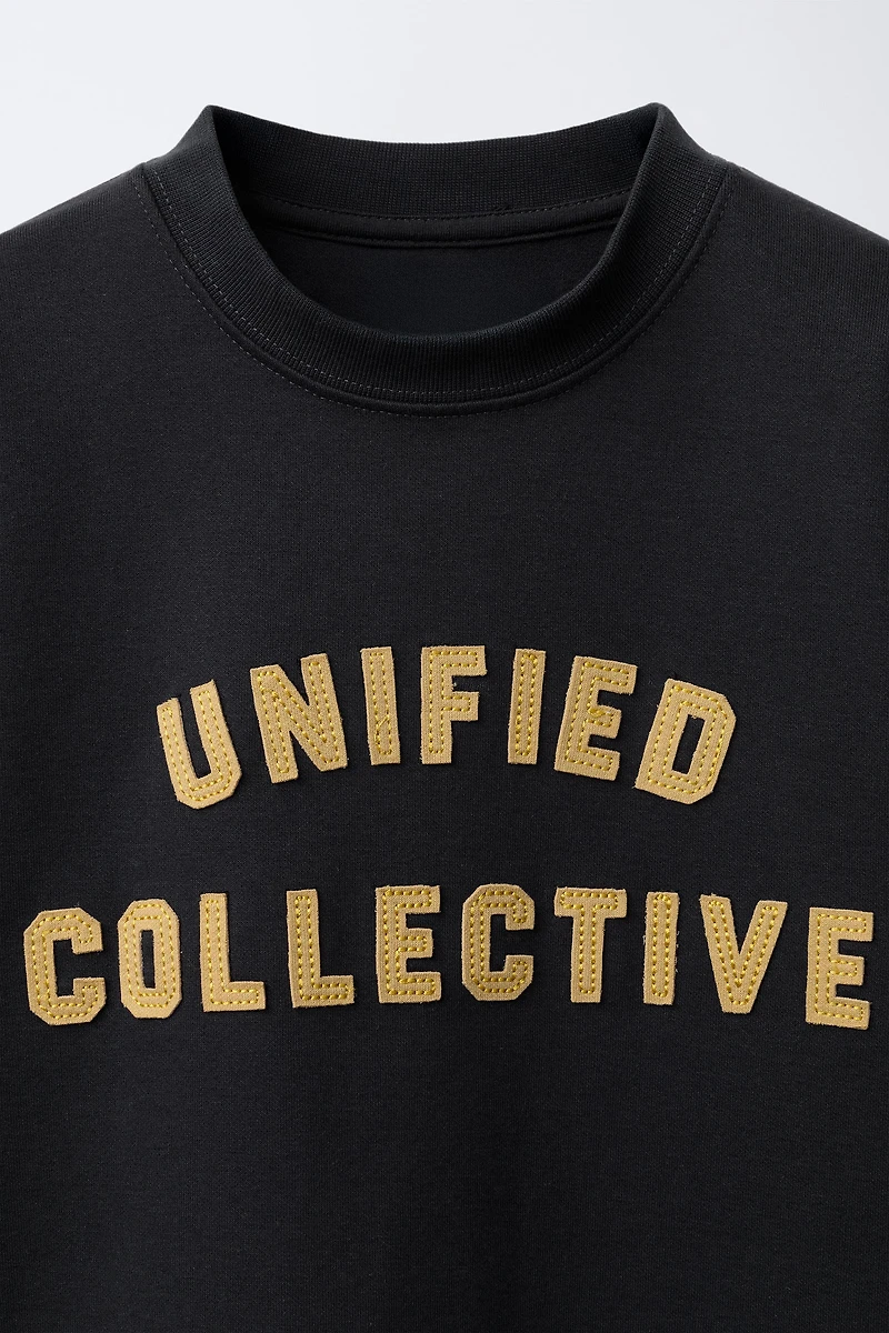 VARSITY INTERLOCK DOUBLE SLEEVE SWEATSHIRT