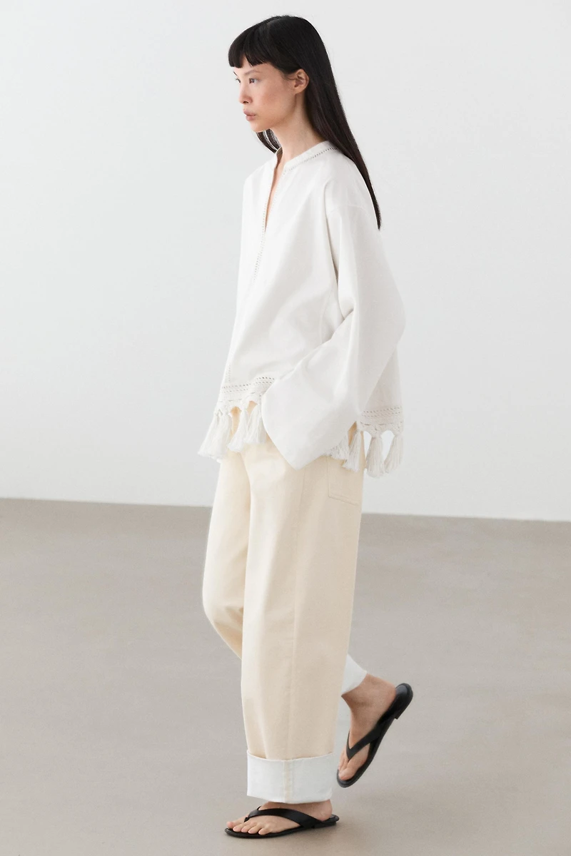 Embroidered blouse with fringed hem