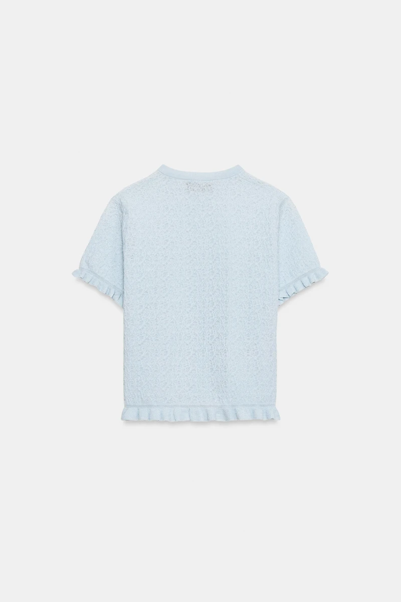 VESTE EN MAILLE STRUCTURÉE À VOLANTS