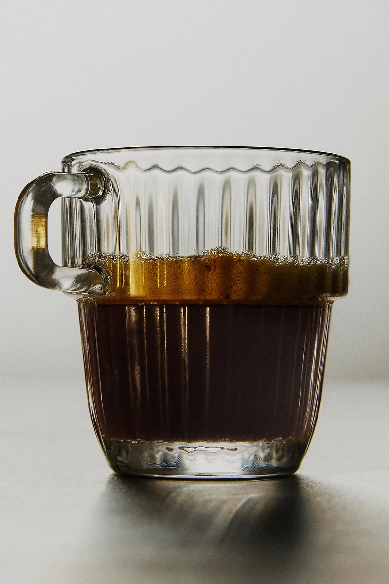 GLASS CUP WITH RAISED DESIGN