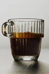 GLASS CUP WITH RAISED DESIGN