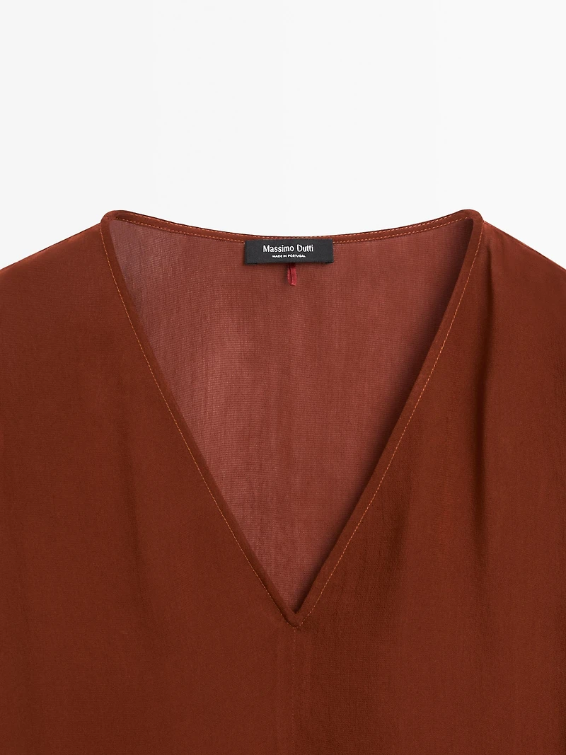 Cape-style blouse with ruffles