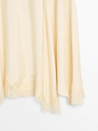 Asymmetric skirt with lace-trimmed detail