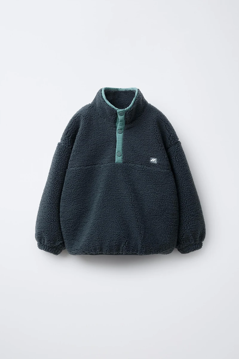 FAUX SHEARLING SWEATER WITH RUBBERIZED LOGO