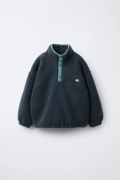 FAUX SHEARLING SWEATER WITH RUBBERIZED LOGO