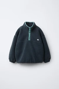 FAUX SHEARLING SWEATER WITH RUBBERIZED LOGO