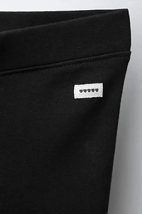INTERLOCK FLARE LEGGINGS WITH LABEL DETAIL