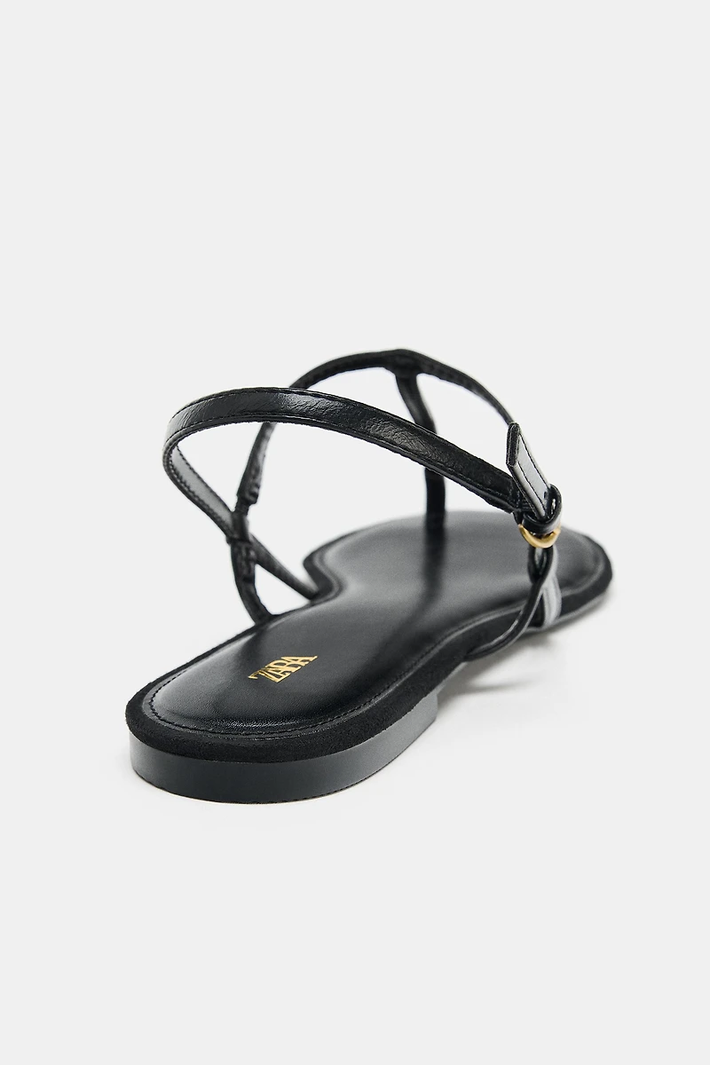 FLAT SANDALS WITH METALLIC APPLIQUE