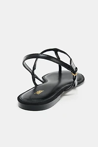 FLAT SANDALS WITH METALLIC APPLIQUE