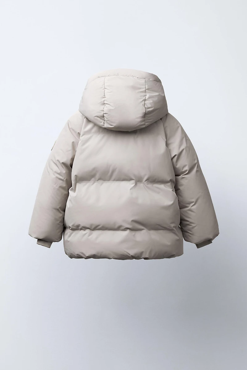 MANTEAU AVEC ÉTIQUETTE AUTOCOLLANTE DÉPERLANT