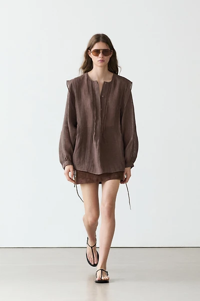 Flowing oversize linen blouse with ruffles