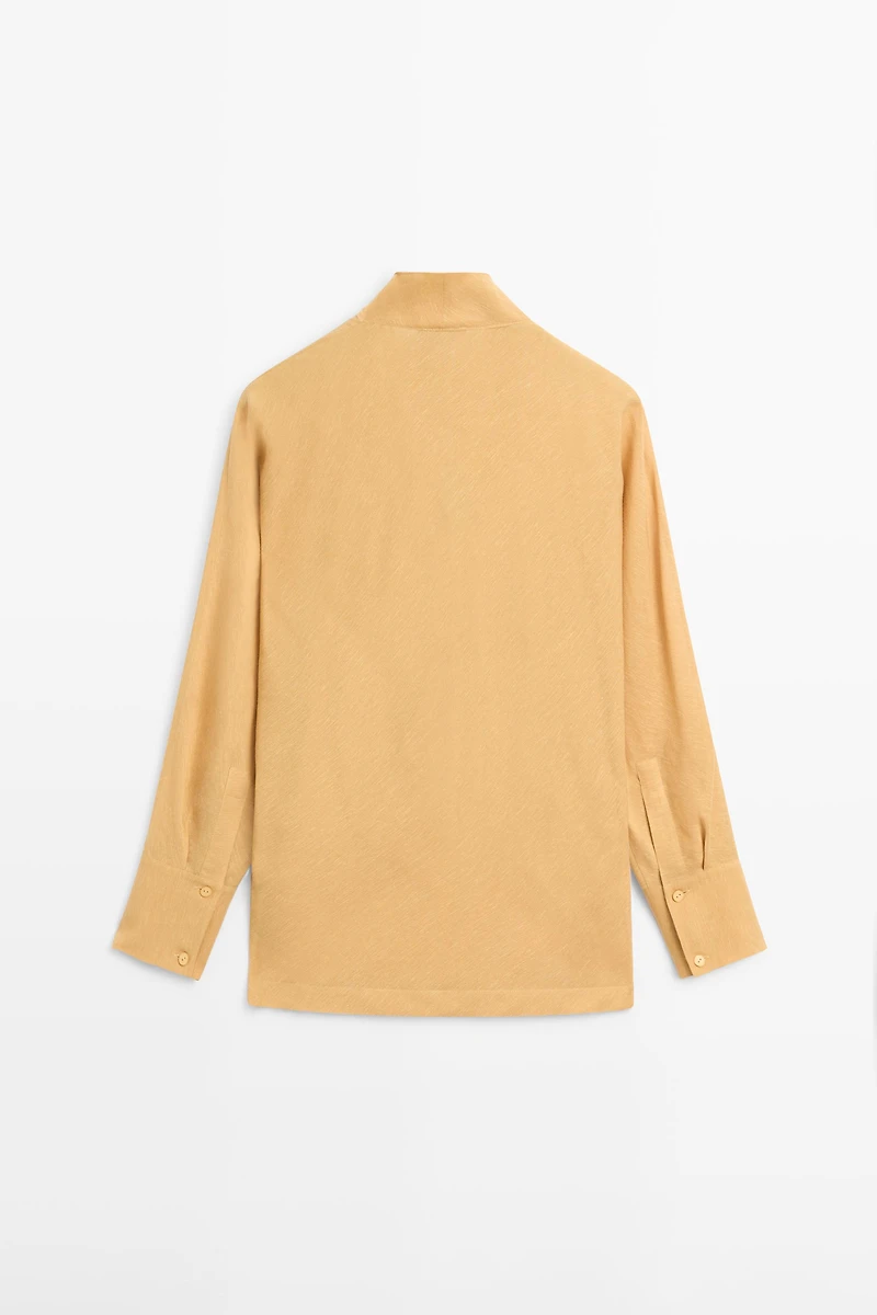 Flowing blouse with draped neckline