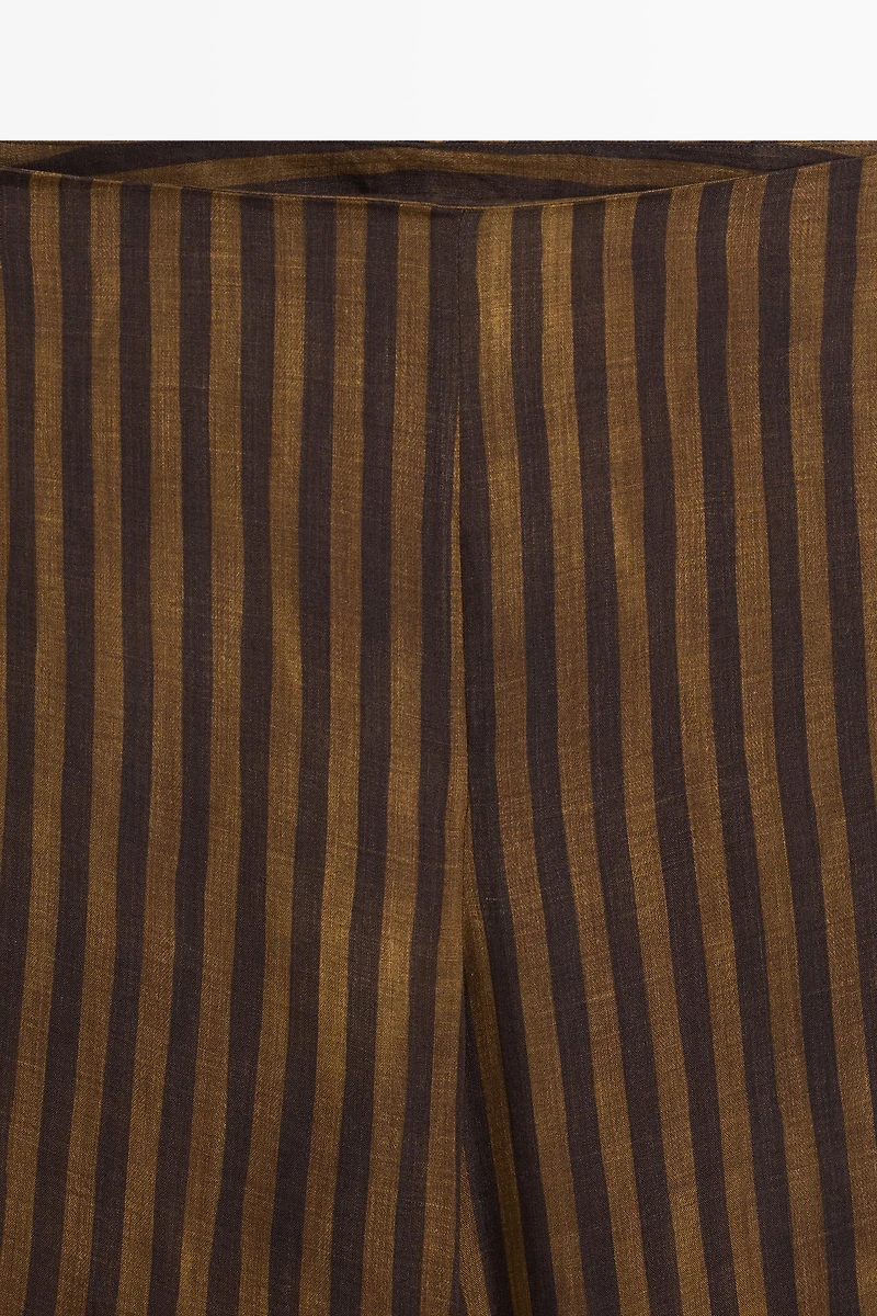 Total look flowing striped pants with button hem