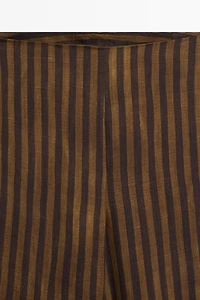 Total look flowing striped pants with button hem
