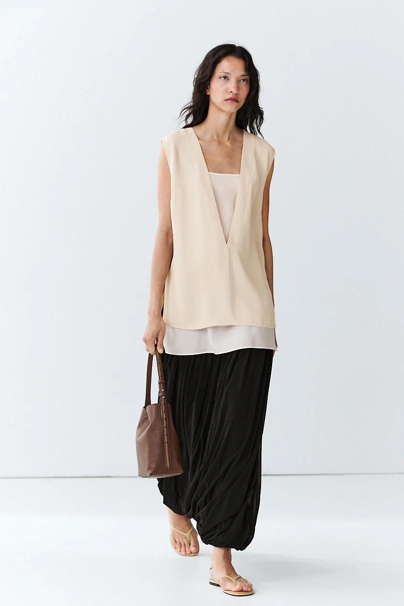 Flowing double-layer top with contrast detail