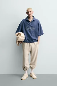 EMBROIDERED TEXT BOXY FIT POLO SHIRT
