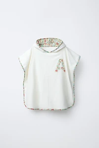 TEXTURED TOWEL PONCHO WITH FLORAL TRIM