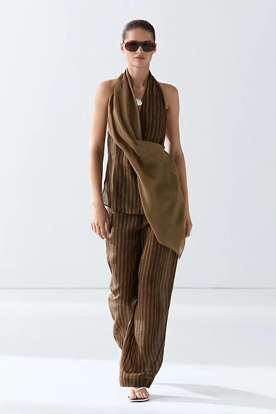 Total look flowing striped pants with button hem