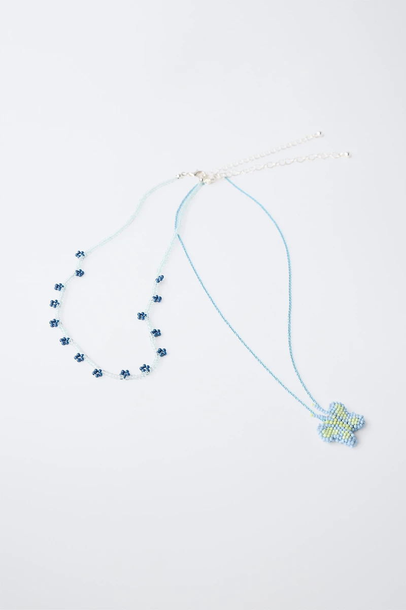 PACK OF TWO BUTTERFLY AND FLOWER BEADED NECKLACES