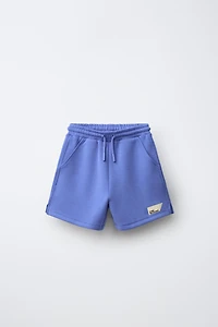 SHORT EN INTERLOCK À ÉTIQUETTE