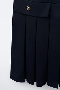 ROBE-SALOPETTE PLIS PLATS