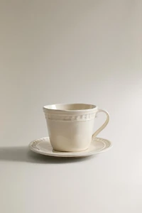 STONEWARE RAISED DESIGN COFFEE CUP AND SAUCER
