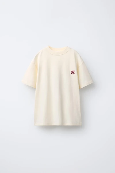 T-SHIRT UNI PIÈCE APPLIQUÉE