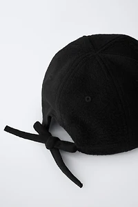 FABRIC CAP WITH BOW CLOSURE