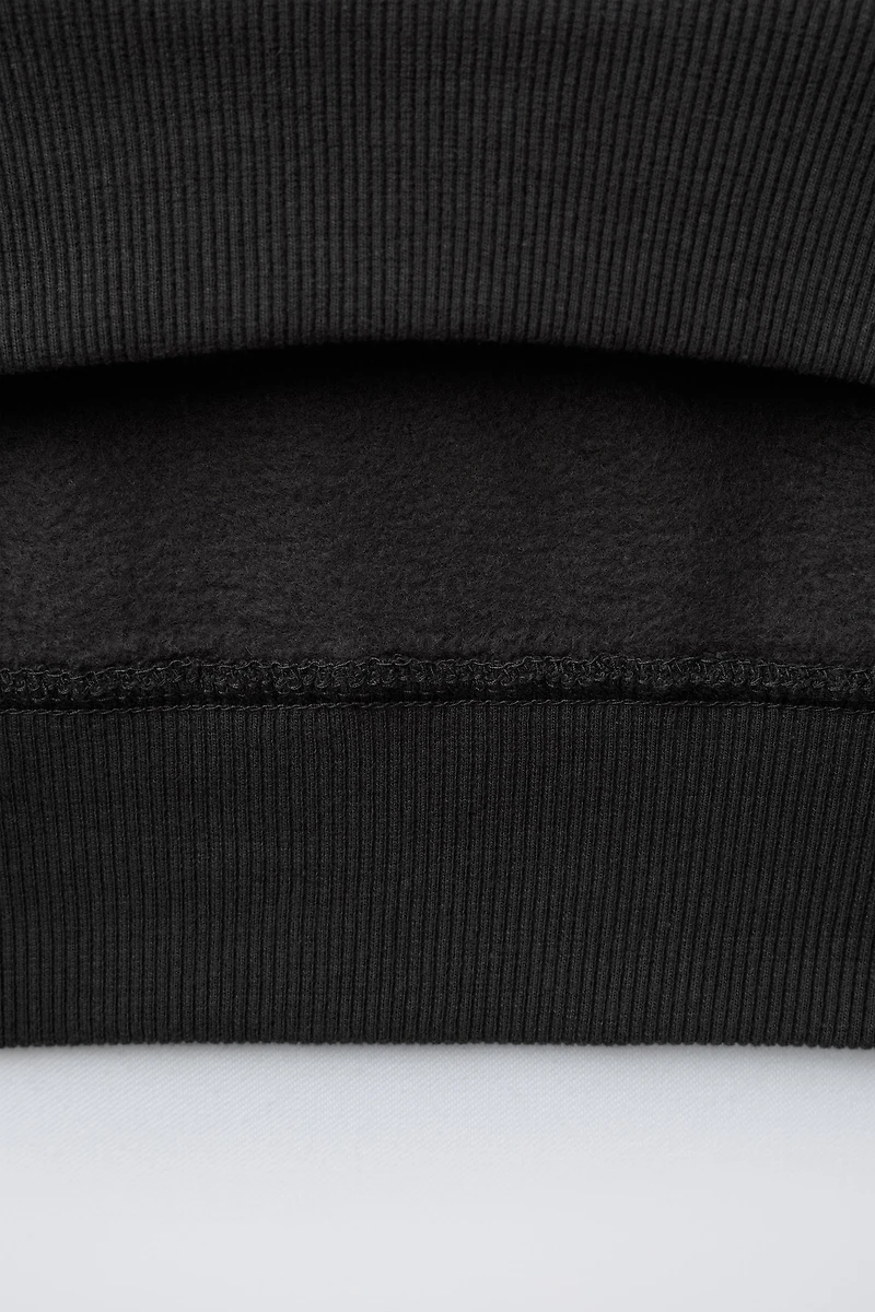 RAISED TEXT SWEATSHIRT