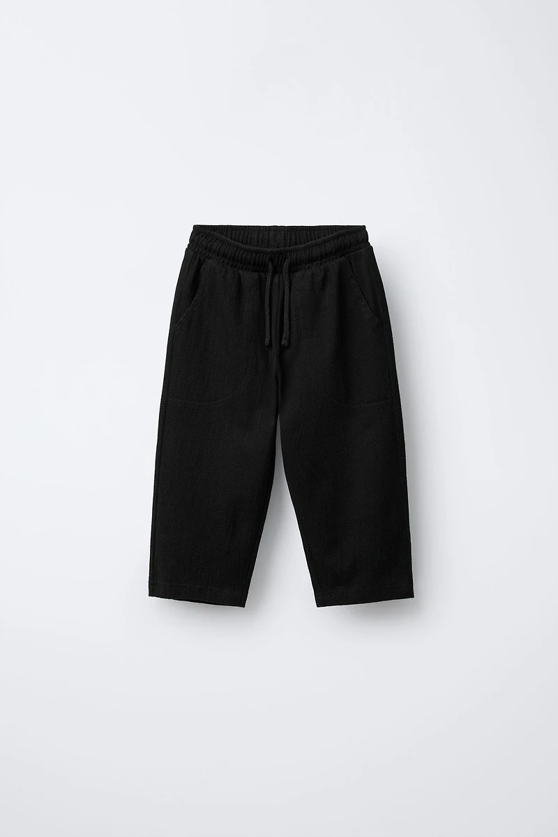 TEXTURED PANTS WITH LABEL