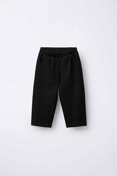 TEXTURED PANTS WITH LABEL