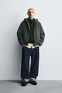 VESTE TECHNIQUE À CAPUCHE