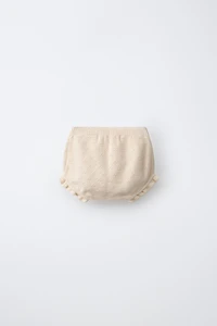 CULOTTE AJOURÉE ET POMPONS