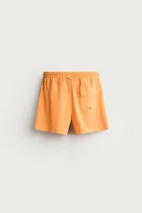 WASHED EFFECT LONG SWIM TRUNKS